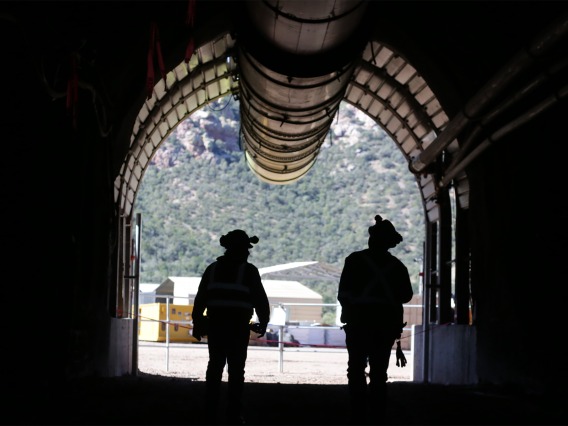 Two miners exiting a portal